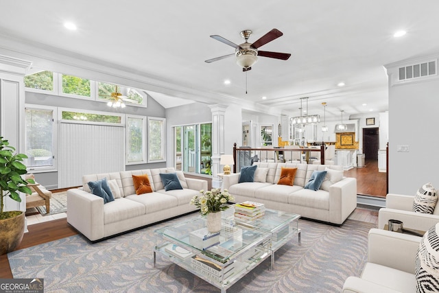 living room featuring hardwood / wood-style flooring, ceiling fan with notable chandelier, and a wealth of natural light