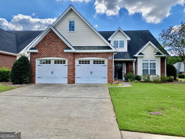 view of front of property with a garage and a front lawn