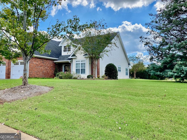 view of front of house with a front yard and a garage