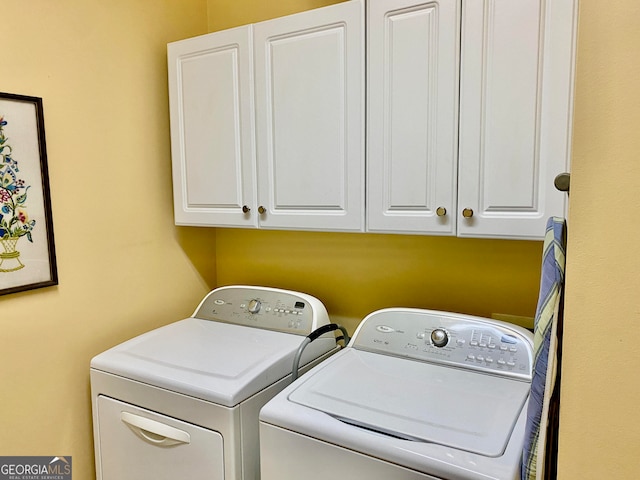 laundry room featuring cabinets and washing machine and clothes dryer