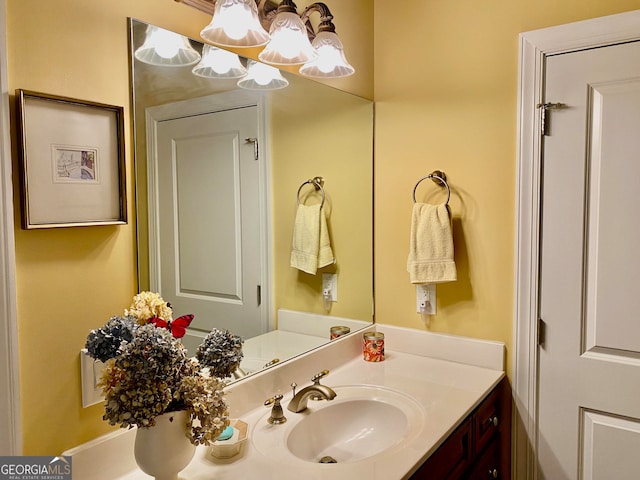 bathroom with vanity and a chandelier