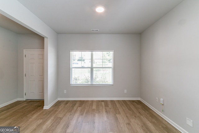 spare room featuring light hardwood / wood-style flooring