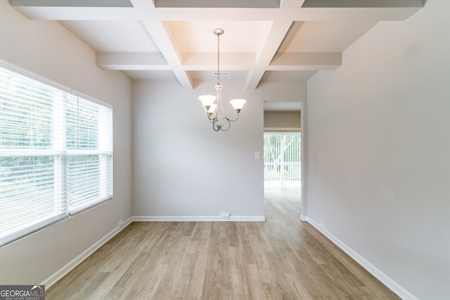 interior space featuring beamed ceiling, light wood-type flooring, a healthy amount of sunlight, and coffered ceiling