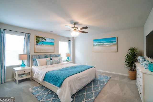 bedroom with ceiling fan and light colored carpet