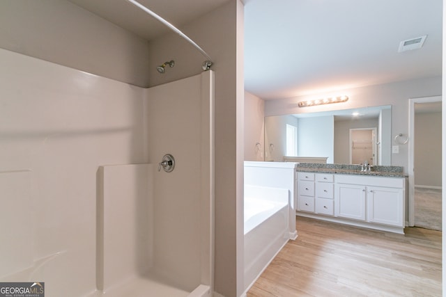 bathroom with vanity, hardwood / wood-style flooring, and separate shower and tub