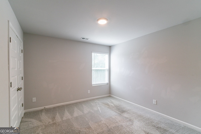 empty room featuring light carpet