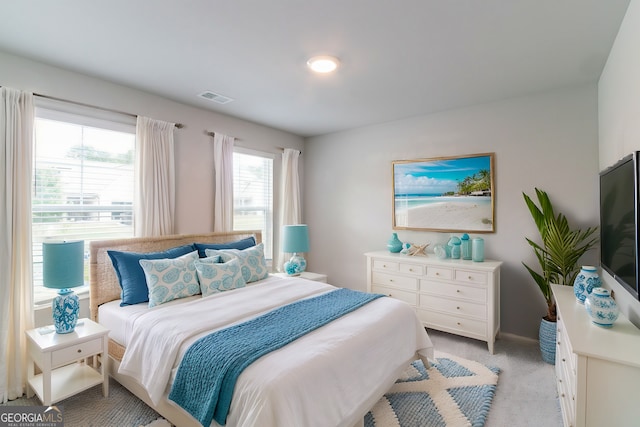 bedroom featuring light carpet