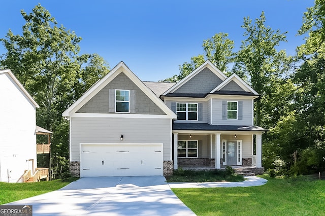 craftsman house featuring covered porch, a front yard, and a garage