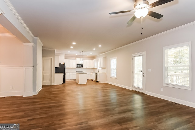 unfurnished living room with ceiling fan, ornamental molding, and dark hardwood / wood-style flooring