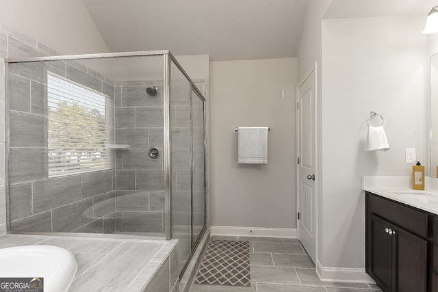 bathroom with vanity, separate shower and tub, and vaulted ceiling