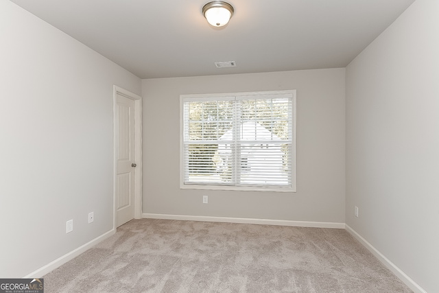 empty room with light colored carpet