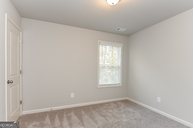 unfurnished room with light carpet