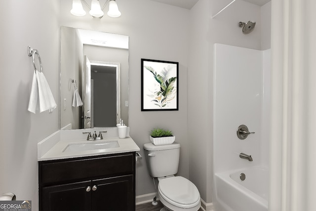 full bathroom featuring washtub / shower combination, vanity, and toilet