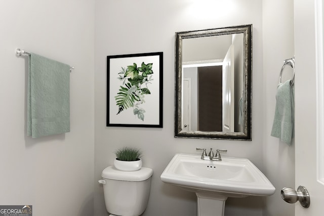 bathroom featuring sink and toilet