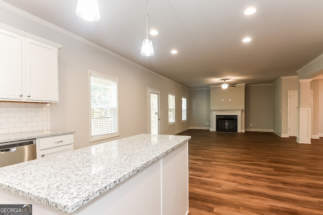 kitchen featuring a center island, white cabinetry, backsplash, dark hardwood / wood-style flooring, and ceiling fan