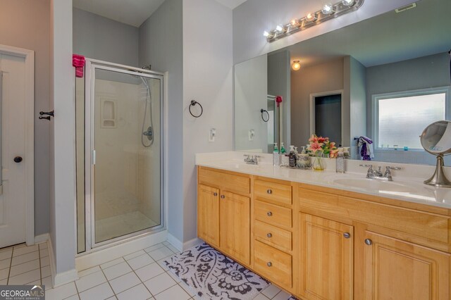 bathroom featuring tile patterned flooring, vanity, and an enclosed shower