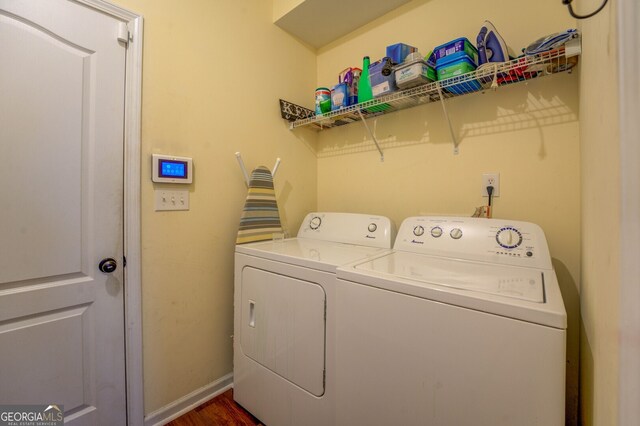 laundry room featuring separate washer and dryer and dark hardwood / wood-style flooring