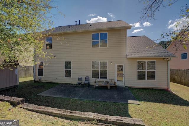 back of house with a lawn and a patio area