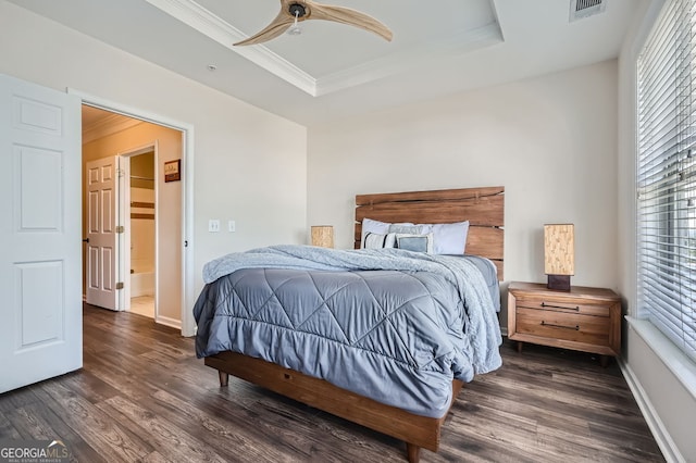 bedroom with a raised ceiling, ornamental molding, dark hardwood / wood-style flooring, and ceiling fan