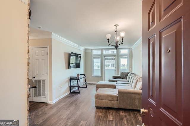 living area featuring ornamental molding, hardwood / wood-style flooring, and a notable chandelier