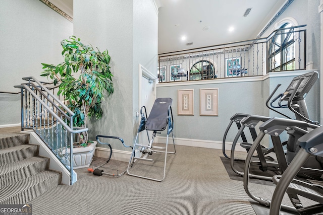 workout room featuring carpet floors and crown molding