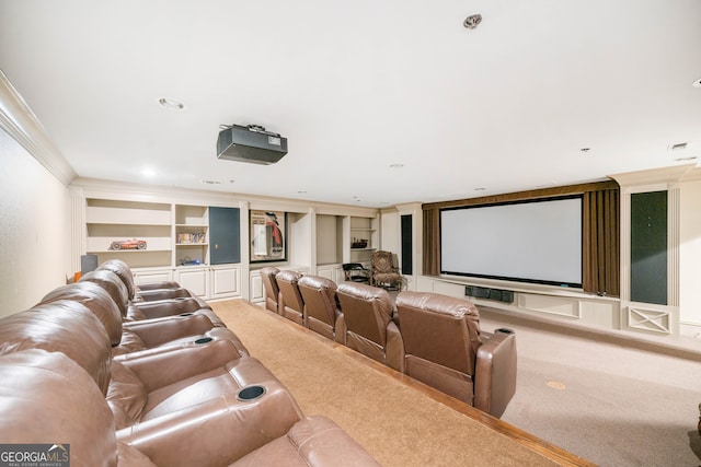 cinema with carpet floors, built in features, and crown molding