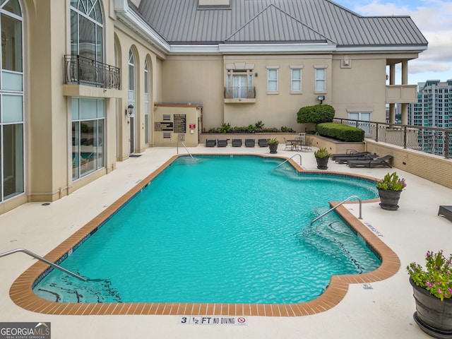 view of swimming pool featuring a patio area