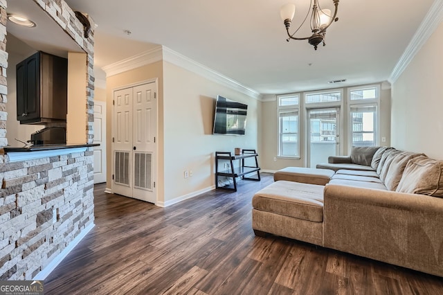 living room with a notable chandelier, crown molding, and dark wood-type flooring