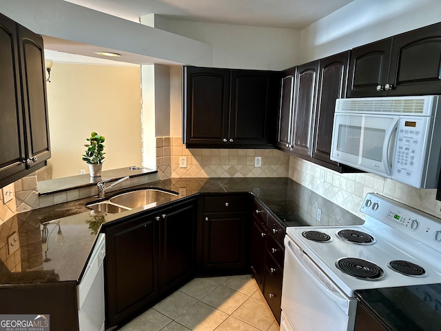 kitchen with light tile patterned flooring, tasteful backsplash, white appliances, sink, and kitchen peninsula