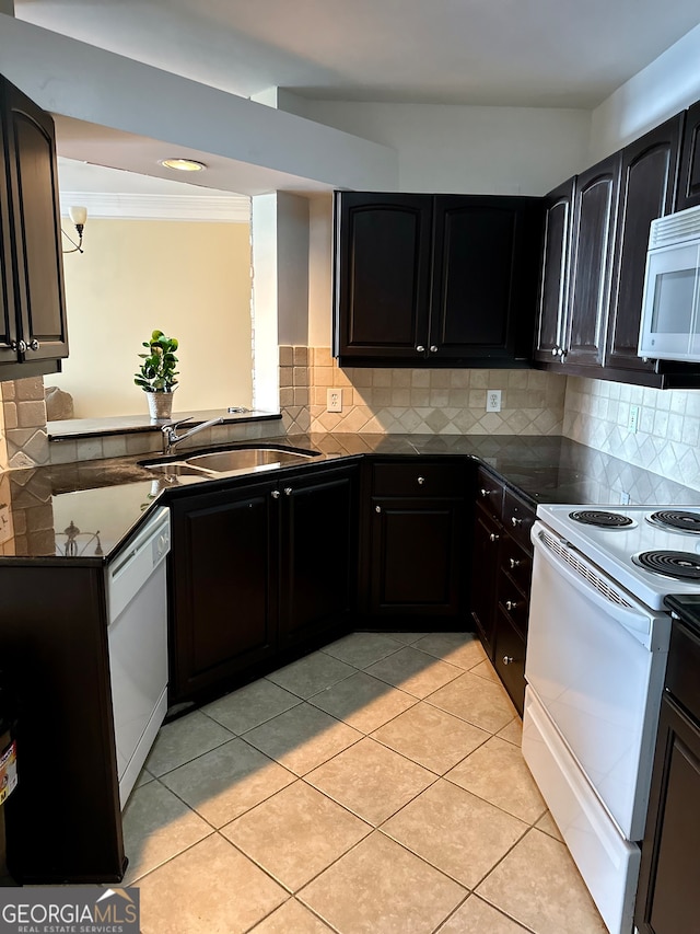 kitchen featuring tasteful backsplash, white appliances, sink, and light tile patterned floors