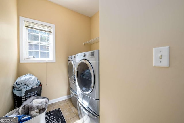 laundry area featuring light tile patterned floors and washing machine and dryer