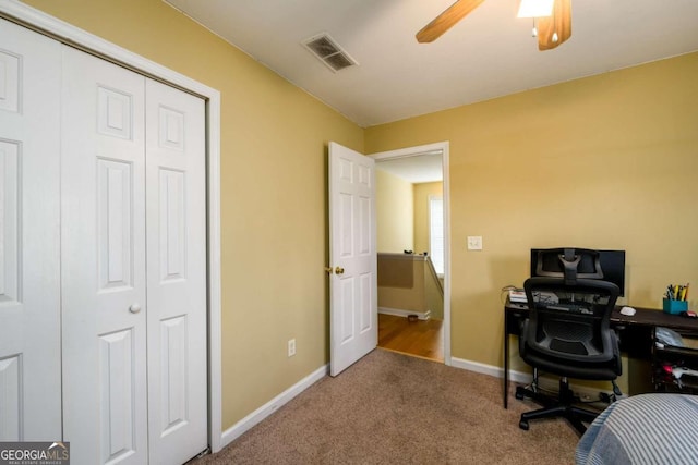 carpeted home office with ceiling fan