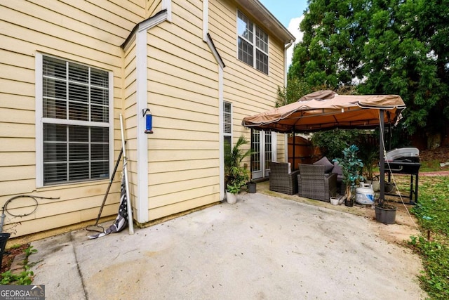 view of side of home with a gazebo and a patio