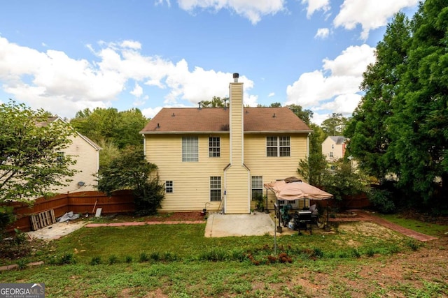 rear view of house featuring a yard and a patio area