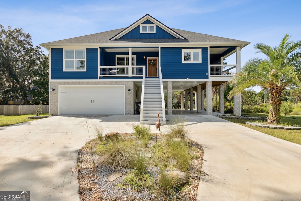 view of front of house with a garage, a porch, and a carport