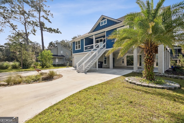 raised beach house featuring a front yard