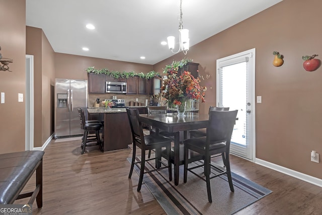 dining room featuring an inviting chandelier and dark hardwood / wood-style flooring