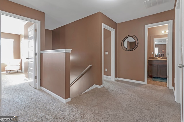 hallway featuring light carpet