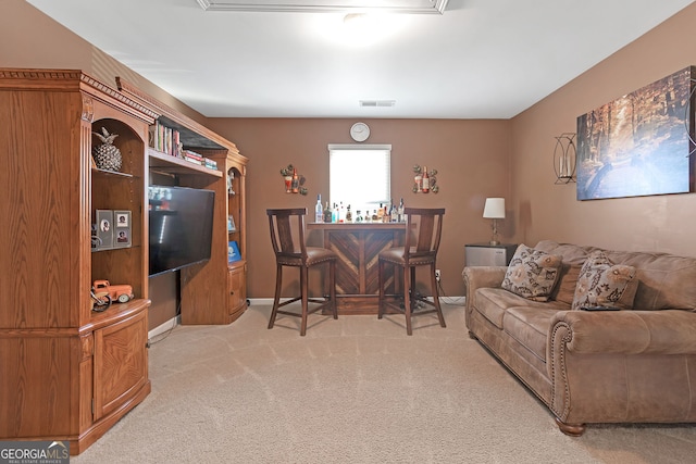 carpeted living room featuring indoor bar