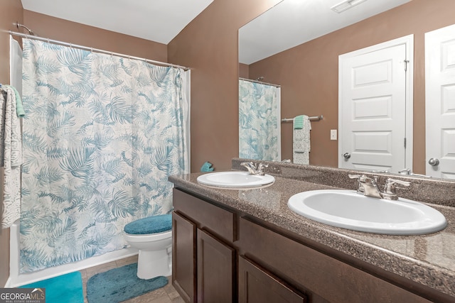 bathroom featuring tile patterned floors, walk in shower, vanity, and toilet