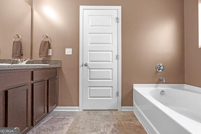 bathroom featuring vanity and a washtub