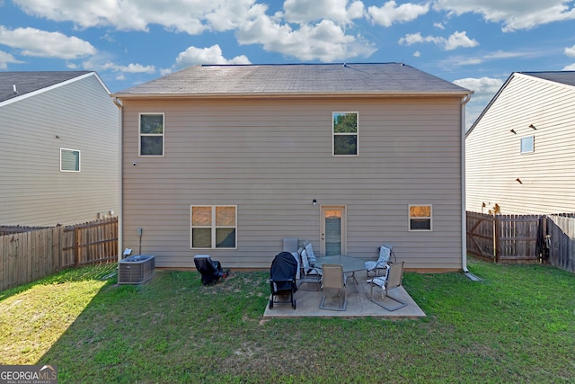 back of house with a lawn, a patio, and central air condition unit