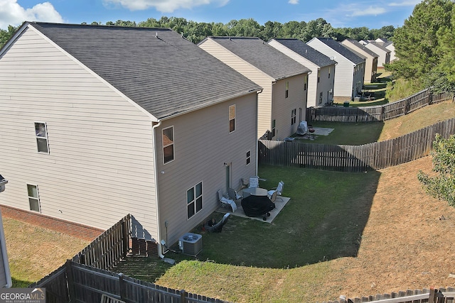 view of property exterior featuring a lawn, central AC, and a patio area