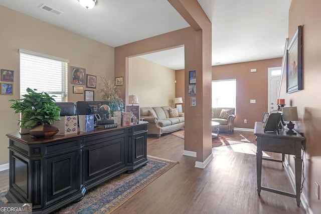 home office with hardwood / wood-style flooring and a healthy amount of sunlight