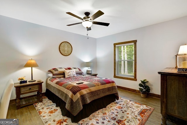 bedroom with ceiling fan and dark hardwood / wood-style floors