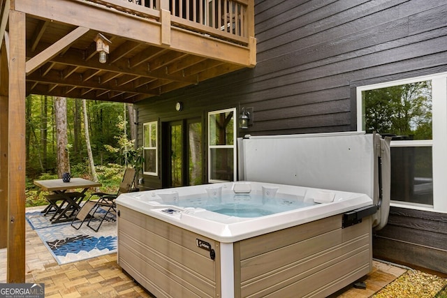 view of patio / terrace featuring a balcony and a hot tub