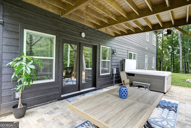 deck with a patio and a hot tub