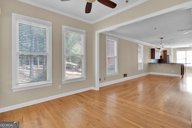 unfurnished living room featuring ceiling fan, light wood-type flooring, and ornamental molding