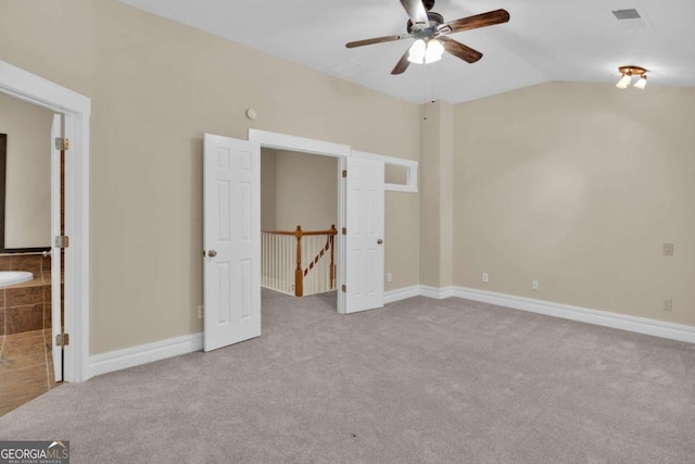 unfurnished bedroom with lofted ceiling, ceiling fan, and light colored carpet