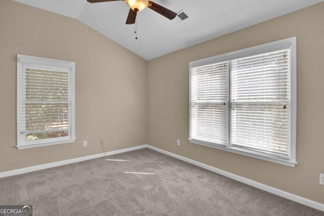 carpeted empty room with lofted ceiling and ceiling fan